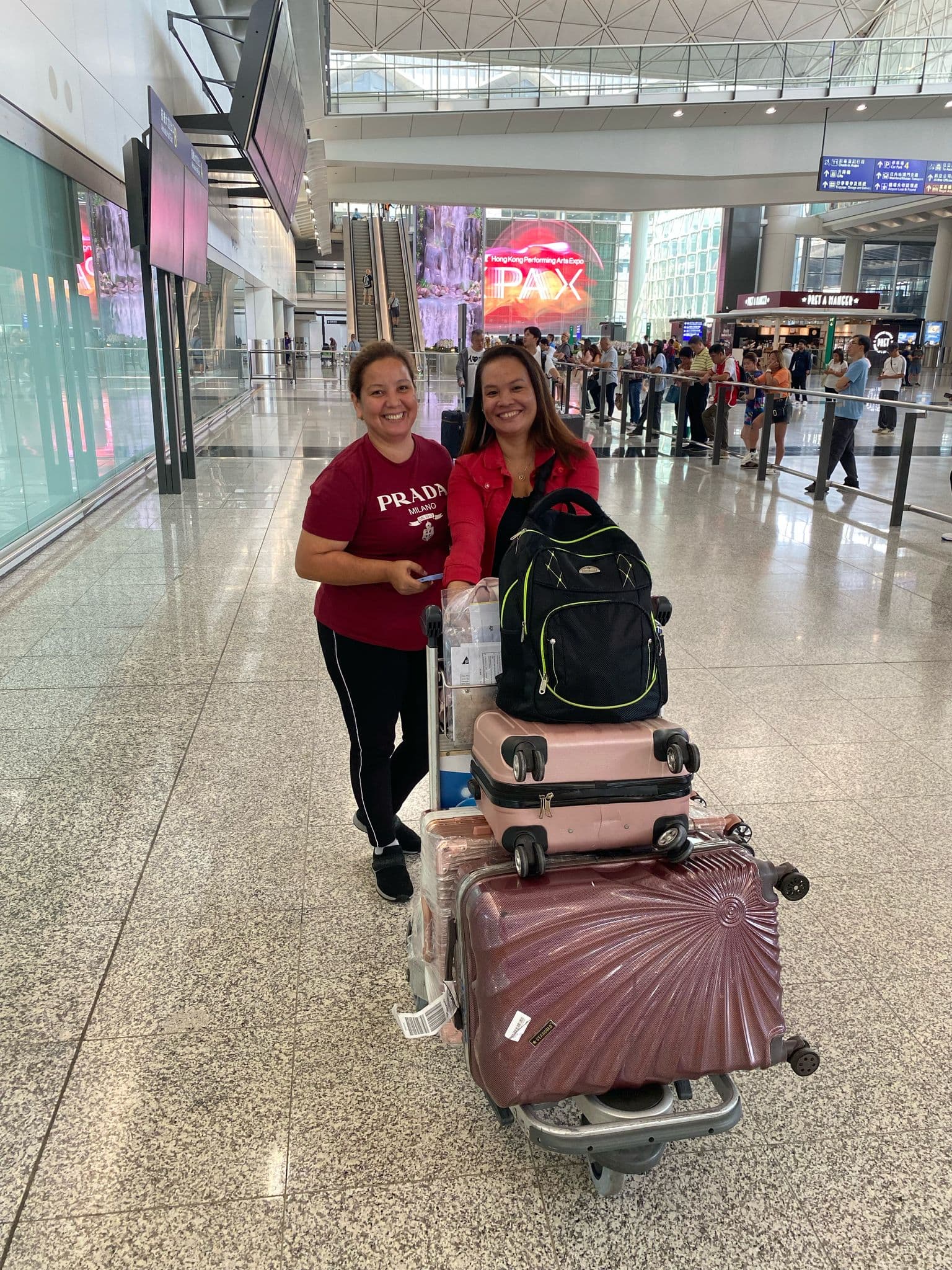 Two helpers arriving together at Hong Kong airport